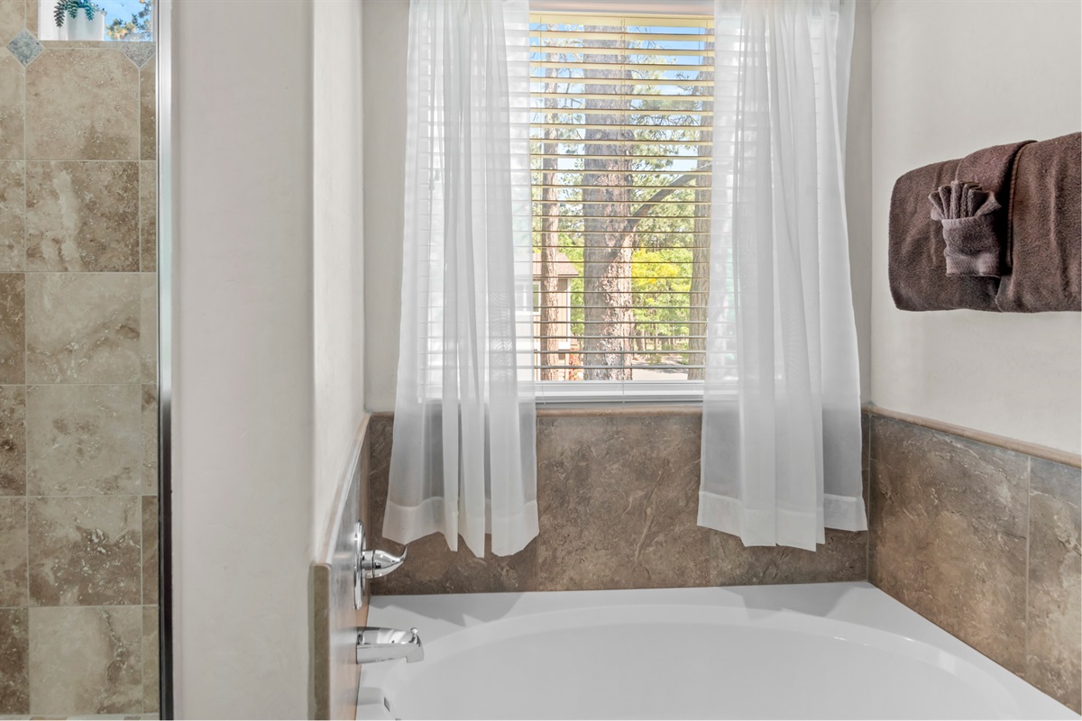 Experience luxury in the master bathroom, featuring a relaxing tub and separate shower.