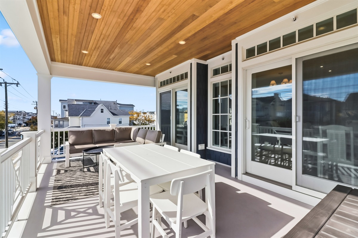 Covered balcony area with outdoor dining