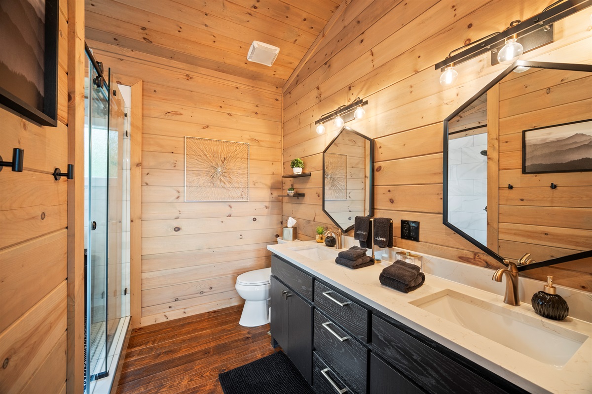 A double vanity with elegant fixtures provides ample space for getting ready in this beautifully designed bathroom.