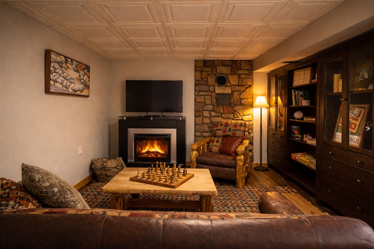 Cozy family room with fireplace, board games and sofa bed