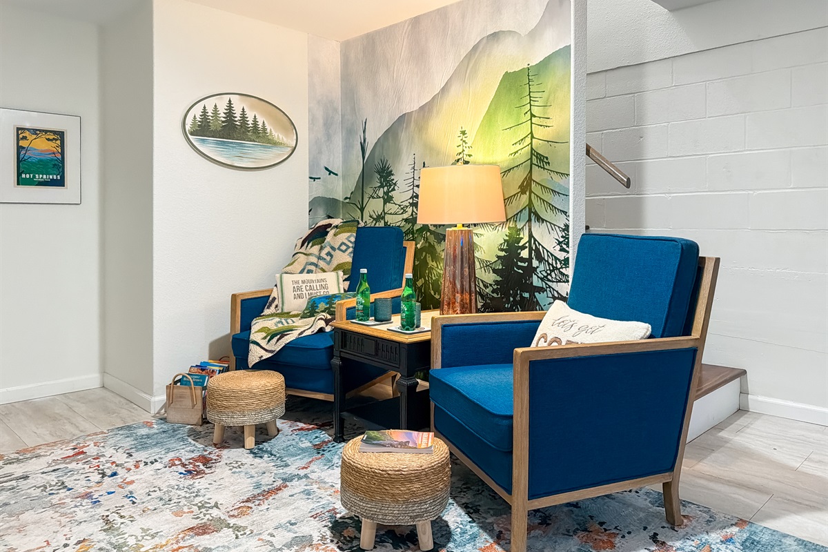 Curl into the reading nook by the forest mural — a screen-free corner for coffee and a slow morning.