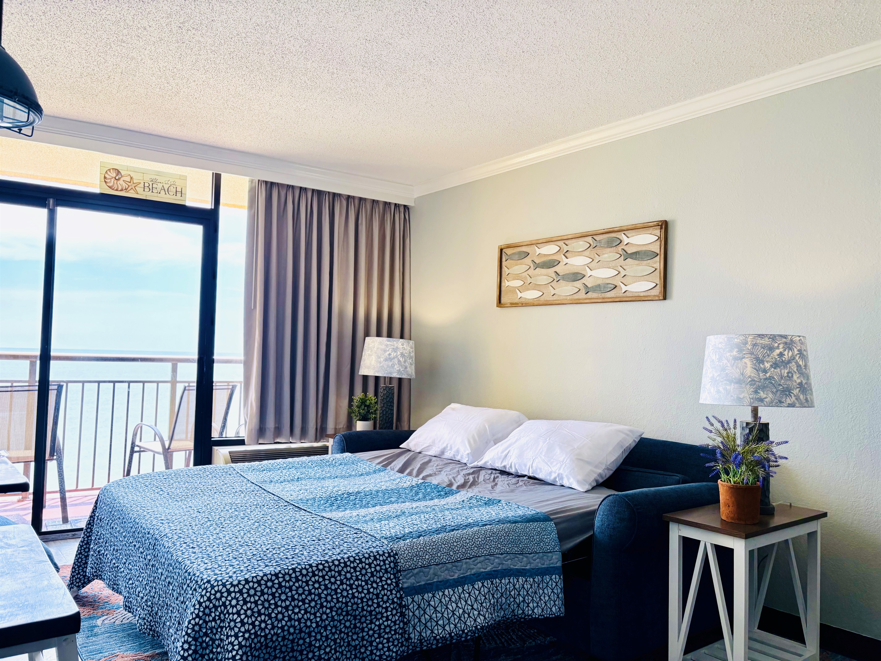 Living Room sofa converts to a queen size sleeper sofa. Take in the ocean from your bed! 