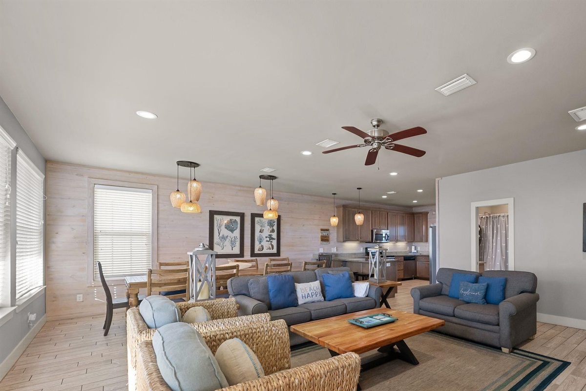 Living room area with plenty of seating and wall mounted Smart TV. Guests must log in to their own streaming services