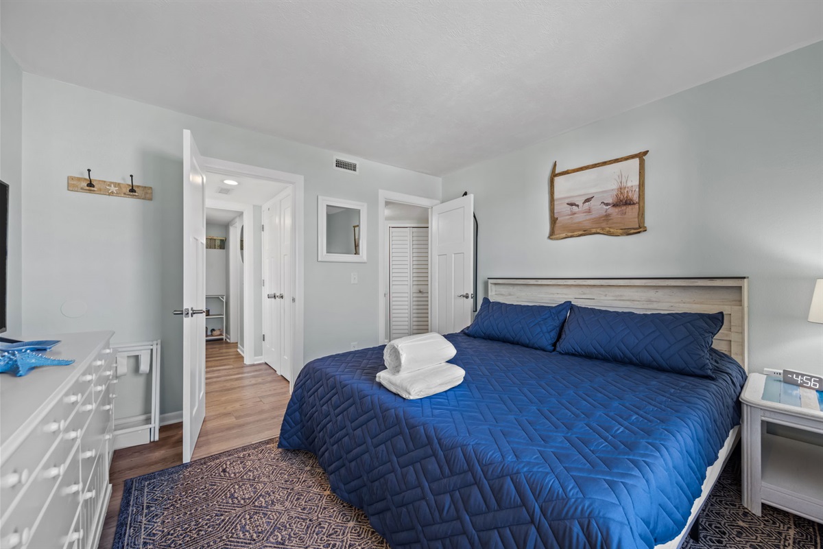 Spacious king suite with TV, ample storage, and easy access to the ensuite bathroom