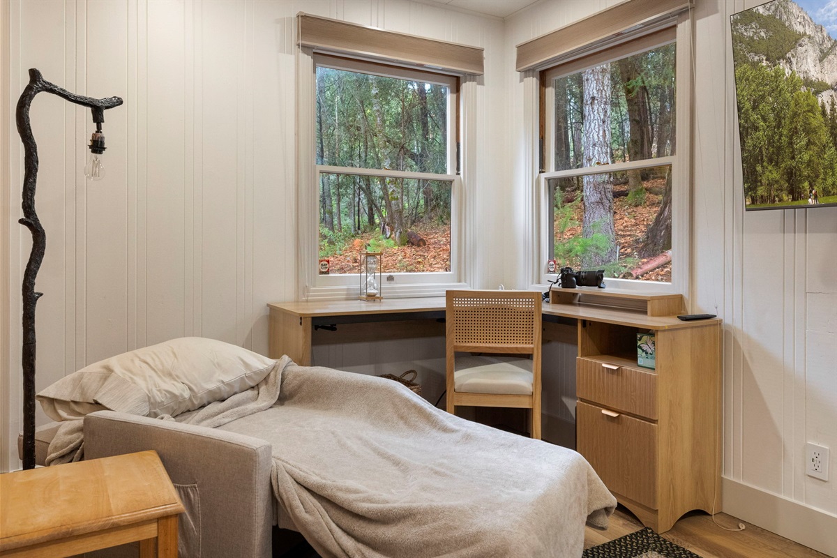 Childs sleeping area on pull out chair in master bedroom.