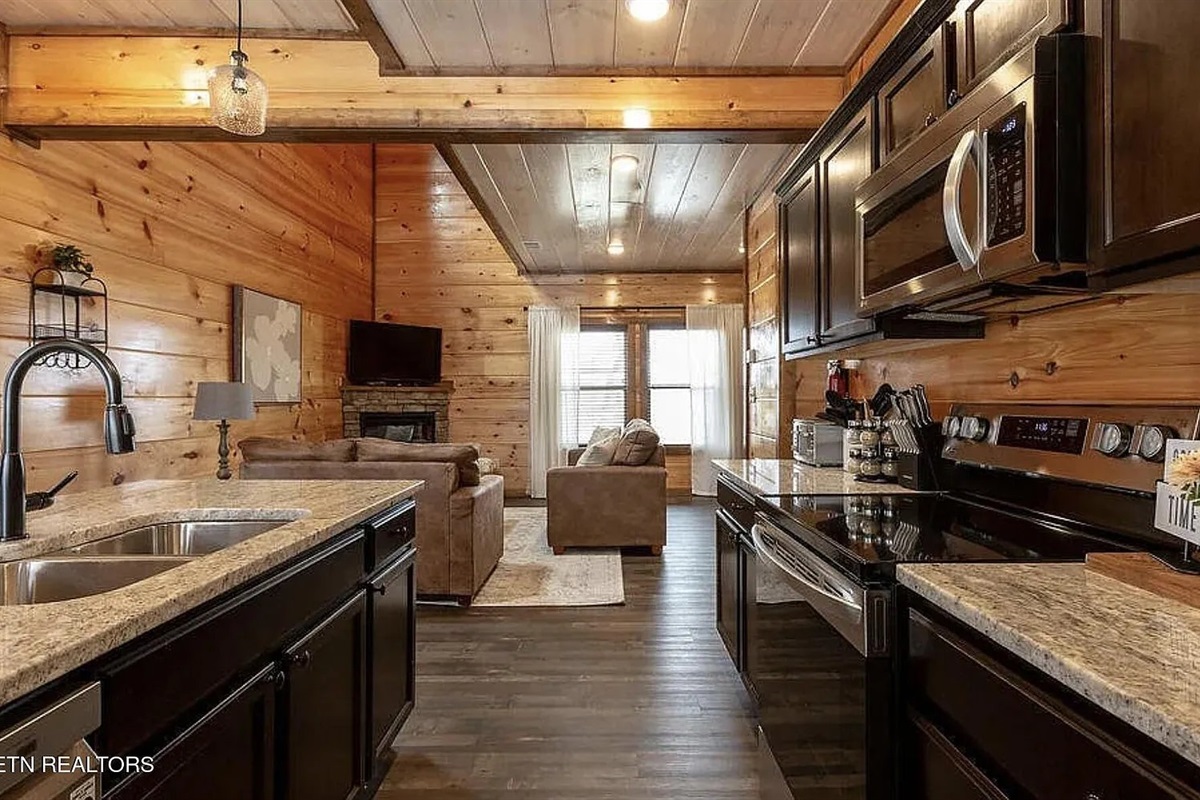 Gather the whole group around the dining area at Marigold Cabin, where the open-concept kitchen and dining room create the perfect space for shared meals and family memories. This 3-bedroom cabin rental in Pigeon Forge, TN seats your entire group comfortab