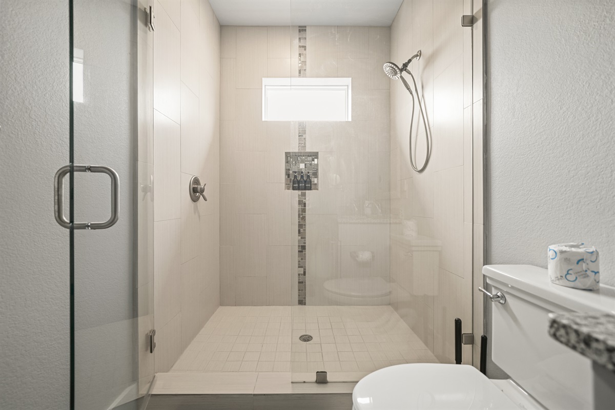 Grand Master ensuite bath featuring a modern walk-in shower with glass enclosure.