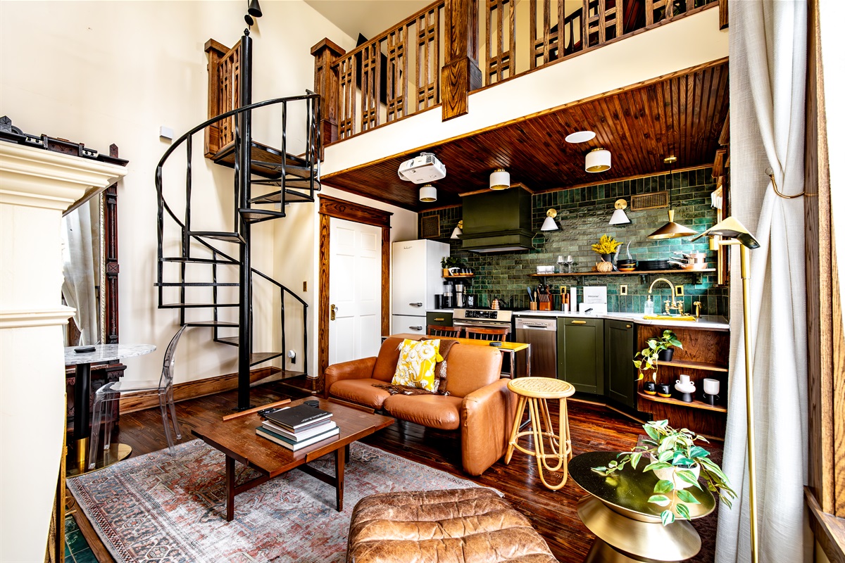 The luxurious kitchen and living spiral up to a spacious bedroom and bath, with masterful design details throughout. Signs of technology and entertainment also peek out - a projector and two ceiling speakers reveal an epic relaxation setup.