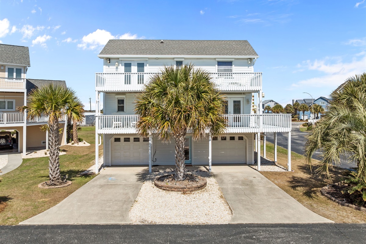 A beautiful coastal home with multiple balconies and plenty of outdoor space to enjoy the sunshine