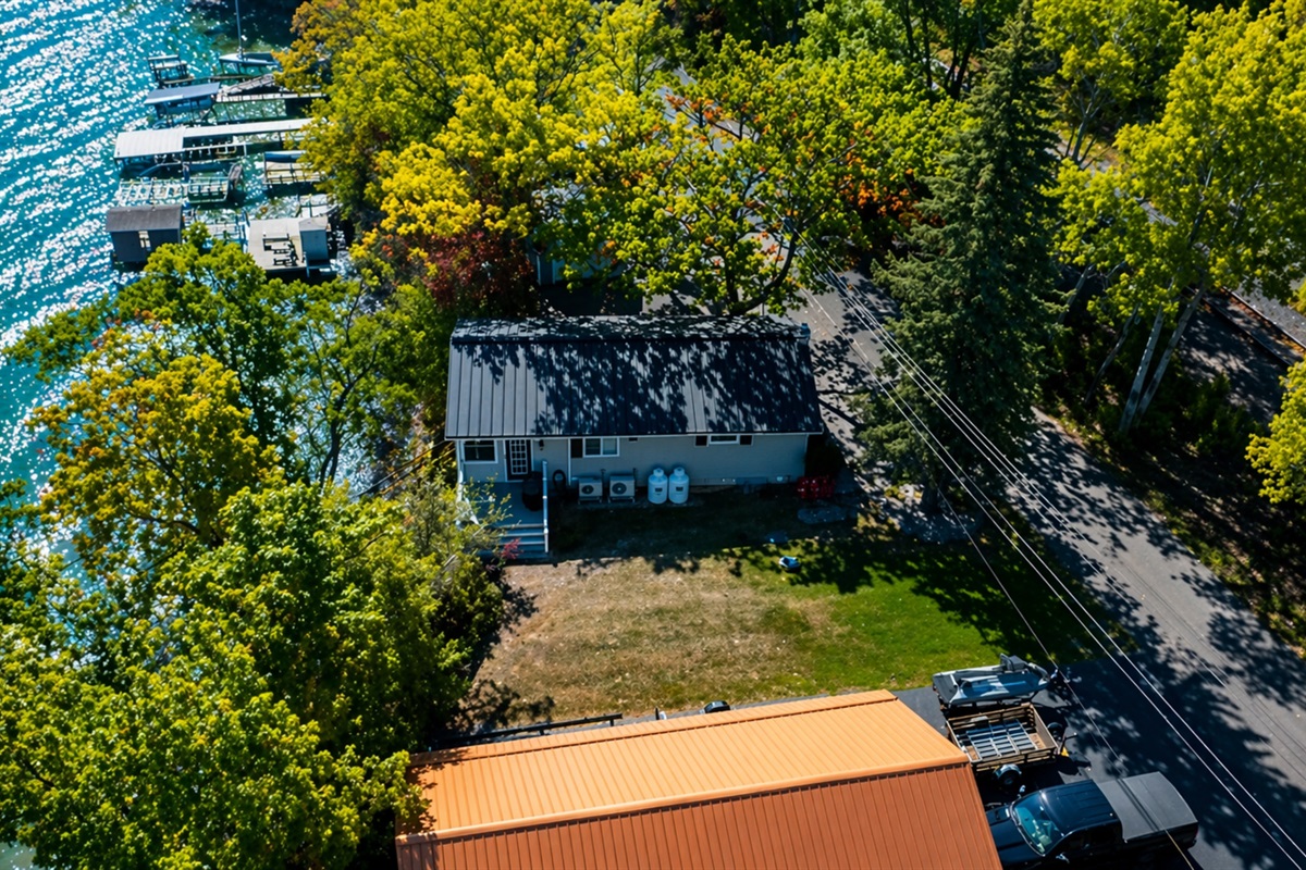Scenic bird’s-eye view showcasing spacious grounds and peaceful wooded setting