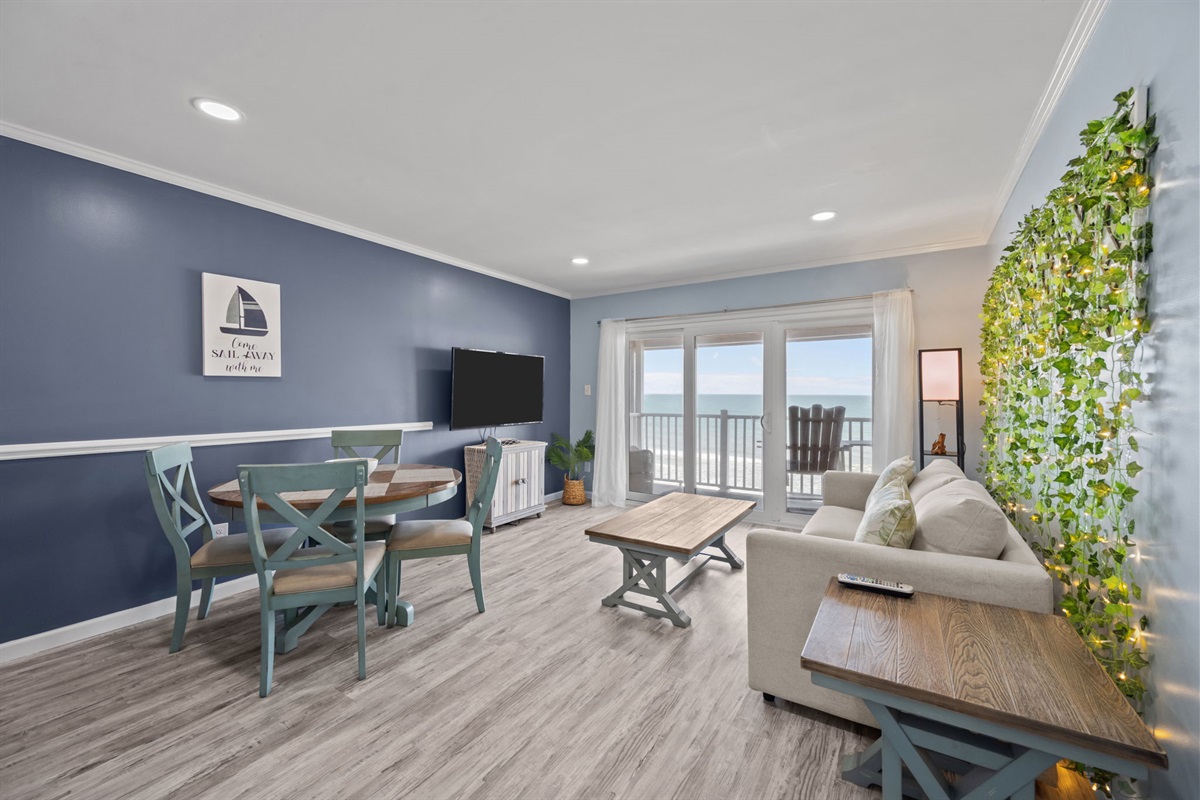 Open-concept layout connecting lounge, dining, and balcony