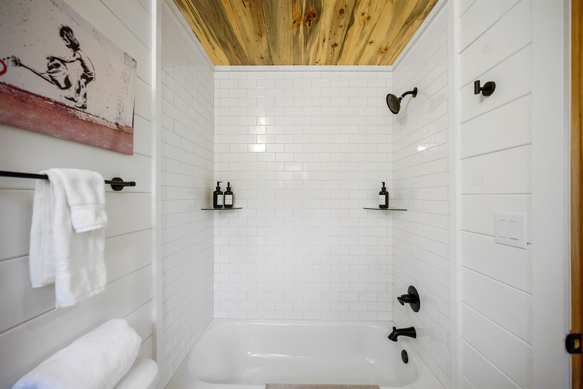 Featuring a full shower and tub combo, modern cabin finishes, and everything needed for relaxing resets after game room nights and outdoor adventures.