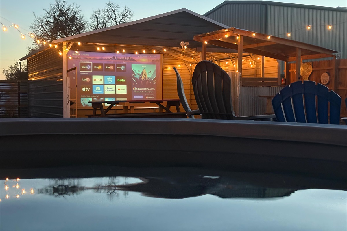 Evenings at The Game Barn - soak, stream, and unwind with movie nights on our 17-ft screen.