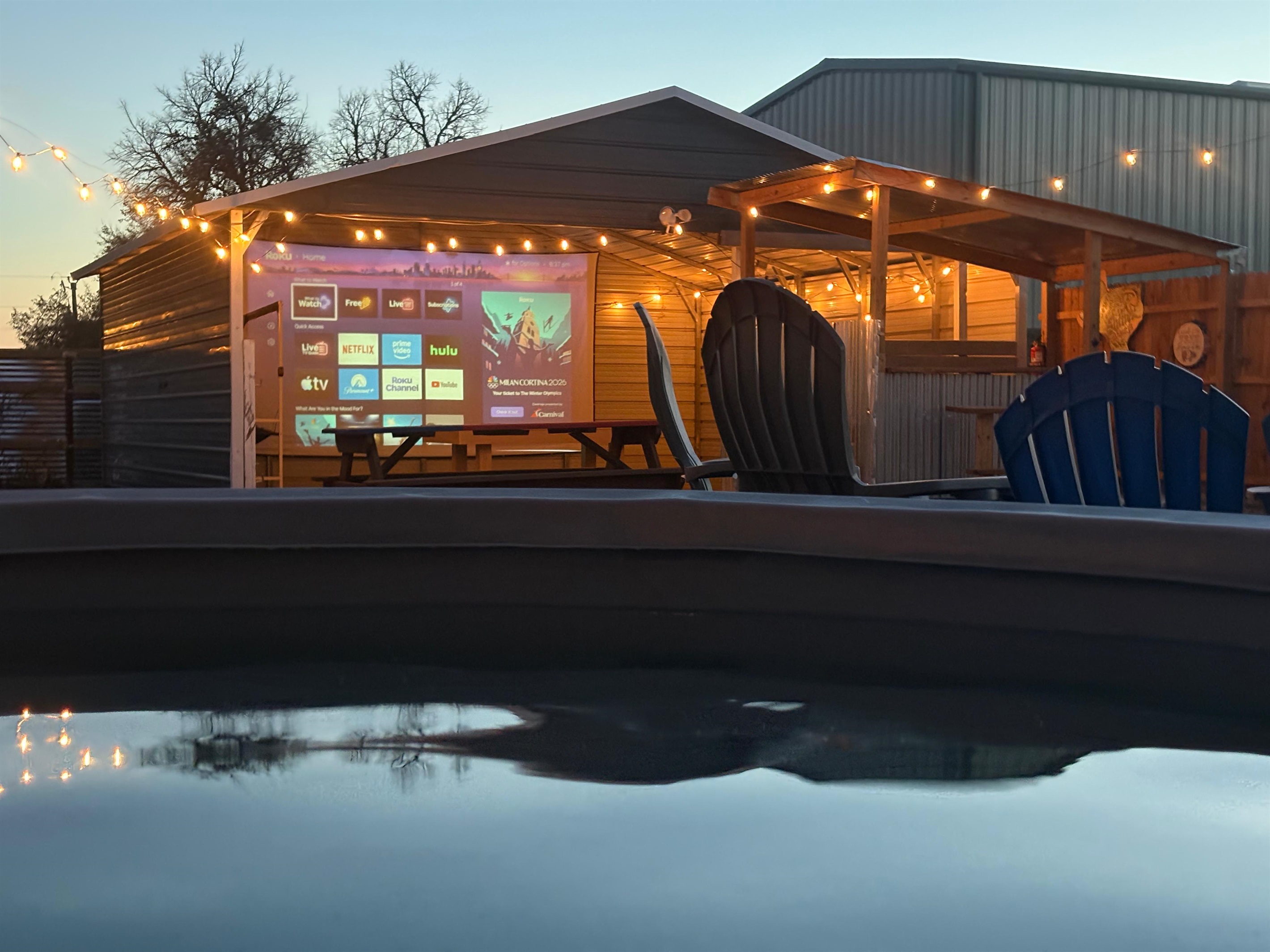 Evenings at The Game Barn - soak, stream, and unwind with movie nights on our 17-ft screen.