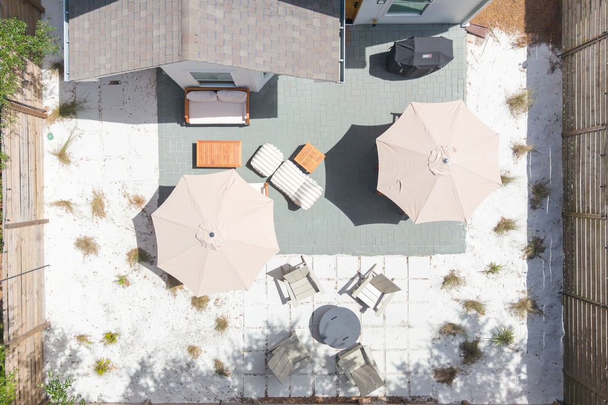 Privacy is an understatement in this resort style back yard oasis equipped with powder like sand, native grasses, multiple seating areas, a grill, dining table and massive fire pit.