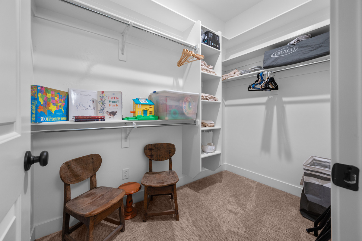 Large kids’ closet stocked with books, games, and space for all the little adventurers’ gear.