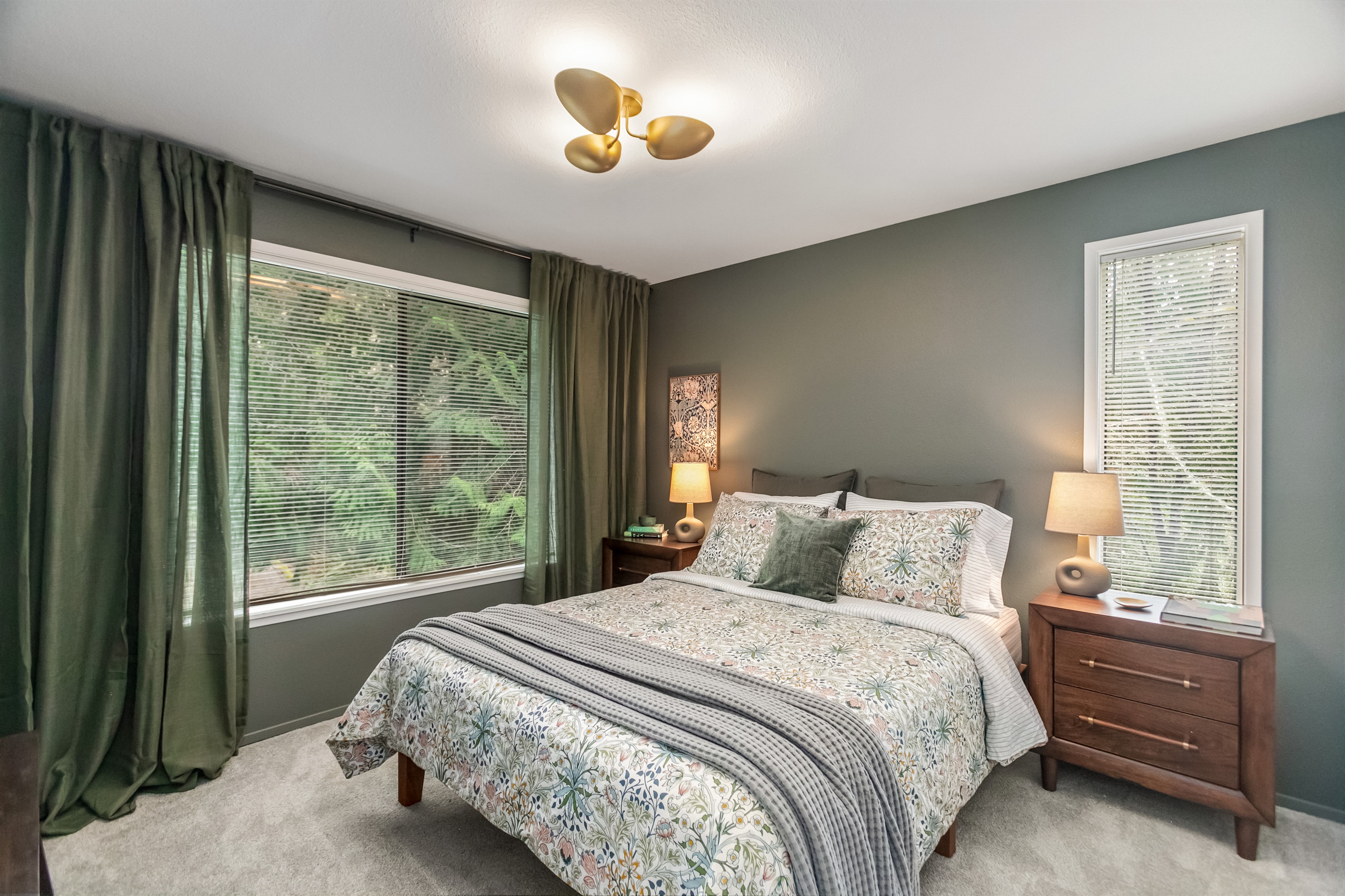 The secondary clean bedroom immerses you in forest green from within and without.