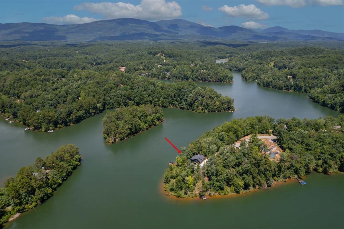 Where the lake house sits surrounded by lake and mountain beauty