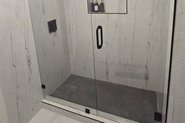 Experience a newly renovated spa-style walk-in shower featuring a luxurious rainfall head, elegant tile finishes, and premium shampoo, conditioner, and body wash—all the essentials for a refreshing, hotel-quality stay. Perfect blend of modern comfort