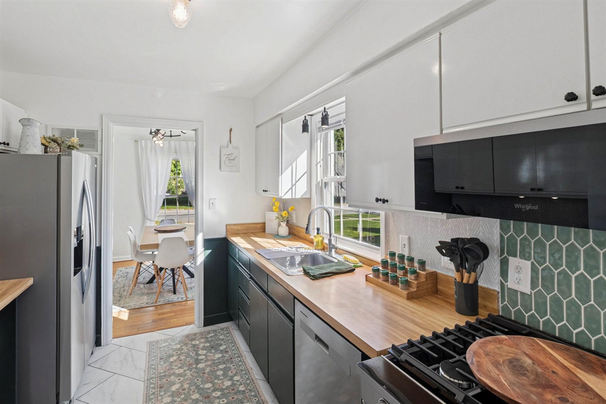 Ready to cook, bake, and gather—our South Bend kitchen features a sleek dishwasher, stainless range, stocked spices, utensils, and a pizza peel for alfresco meals near Notre Dame.