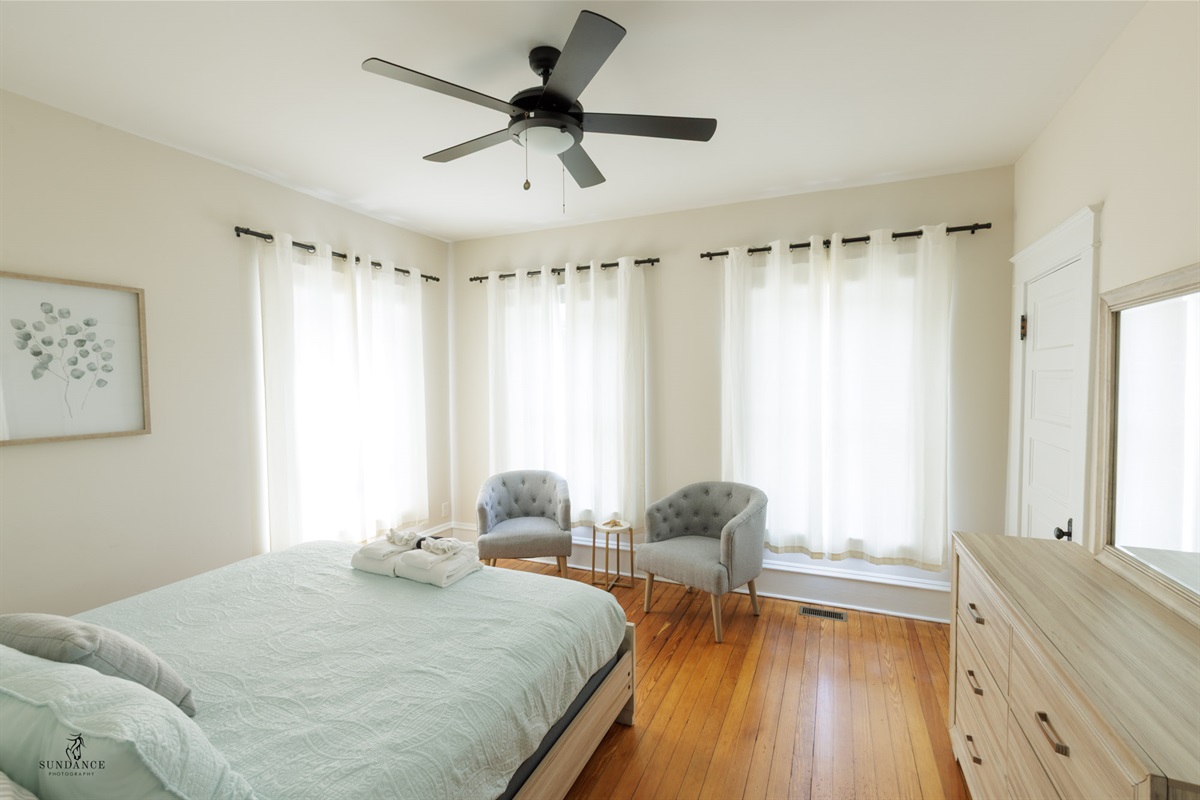 Large King Bedroom with extra seating, clothing storage.