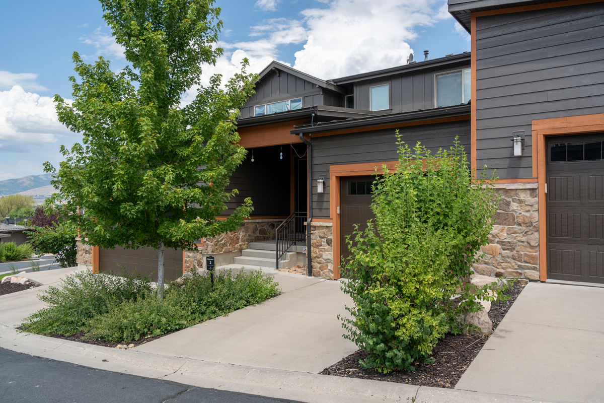 Contemporary multi-unit building with landscaped surroundings.