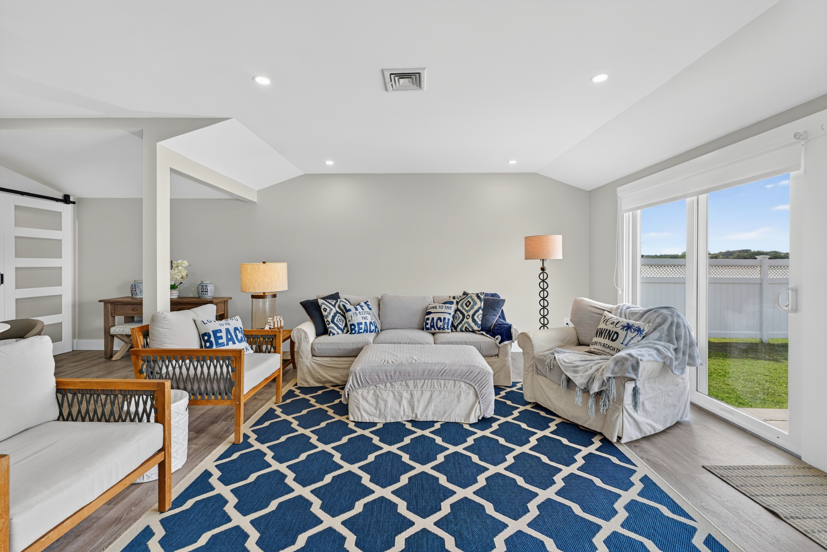 Elegant open-concept living room with cozy furnishings and panoramic waterfront scenery.