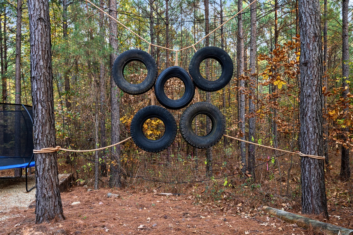 A ring of stacked tires for a tire tossing game that brings just the right amount of adventure to this corner of the woods.