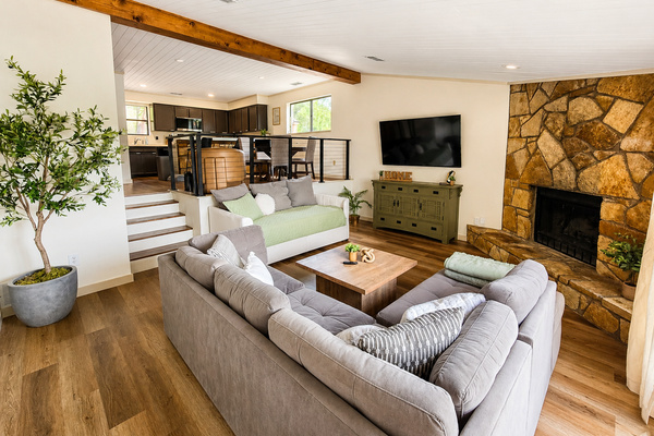Open living room with fireplace and panoramic lake views.