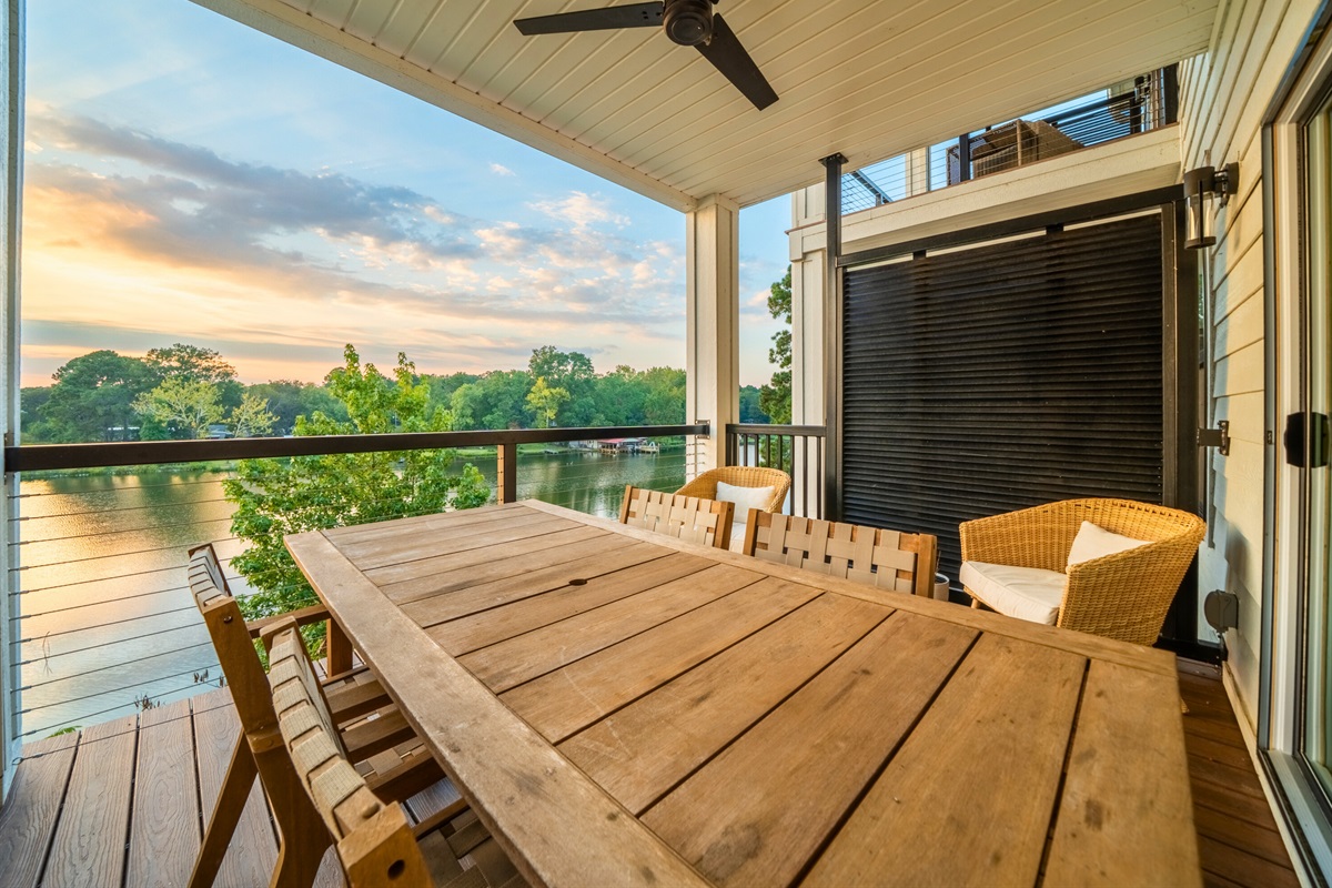Balcony with dining and lounge seating overlooking Lake Hamilton.