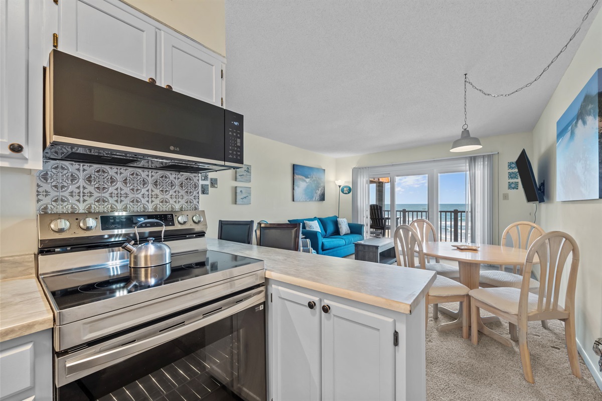 Open-concept kitchen and dining area with ocean views; perfect for cooking, gathering, and enjoying the sea breeze together