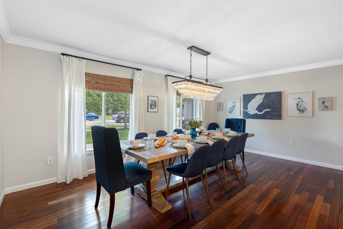 Natural light and an eye-catching chandelier highlight this sophisticated dining room.