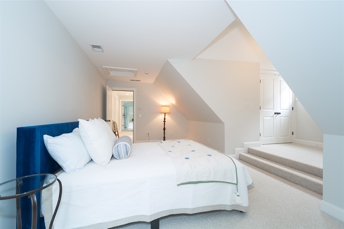 Upstairs Bedroom 4 offers a restful escape with a plush queen bed