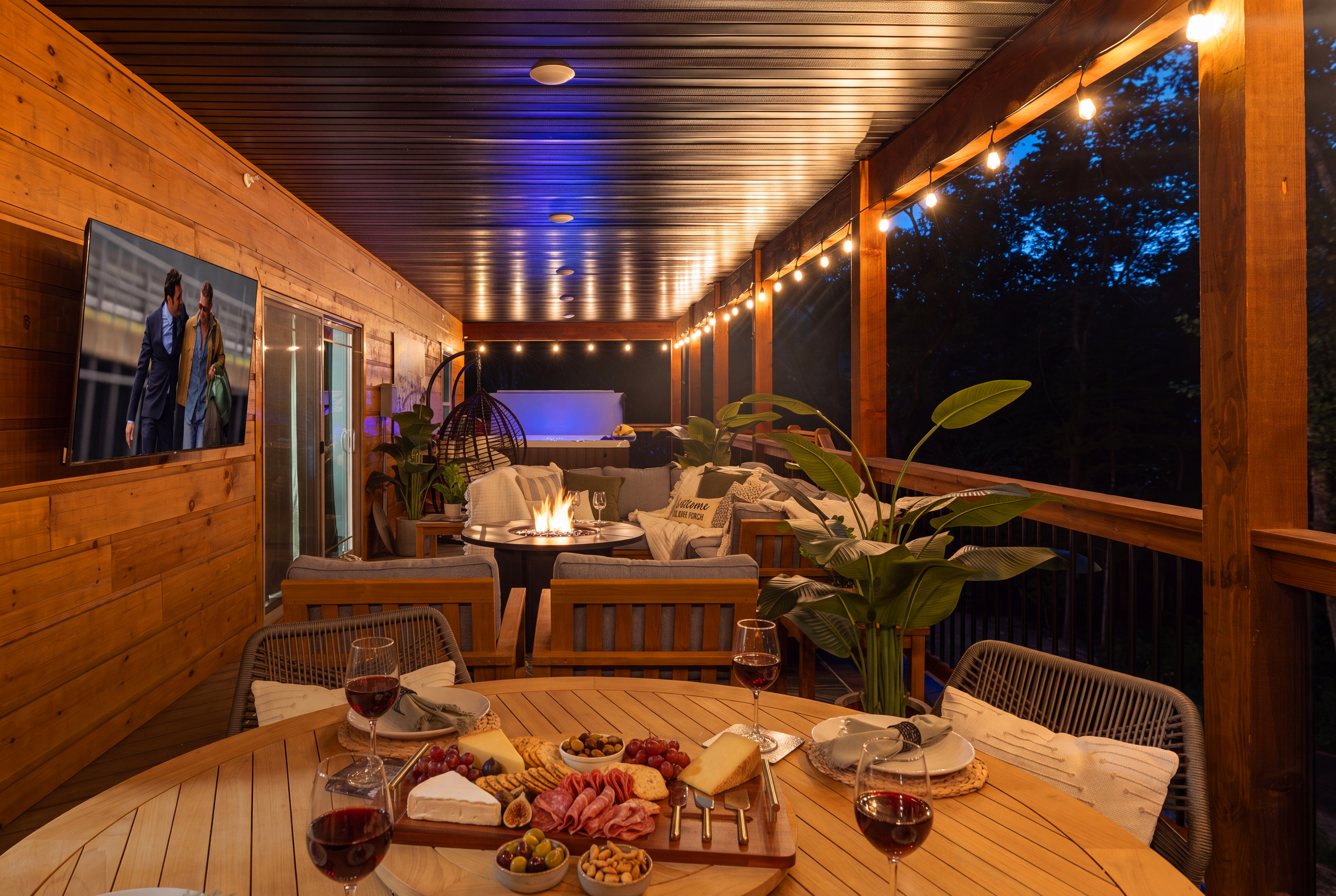 Warm lights and a late-night board on the deck table.