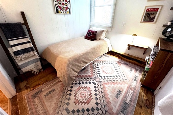 Both downstairs bedrooms have smart TVs and are bathed in natural light.  Appx 8’x9’. This room features an full en suite bathroom and a brand new bed and Casper twin size mattress (Feb 2026).