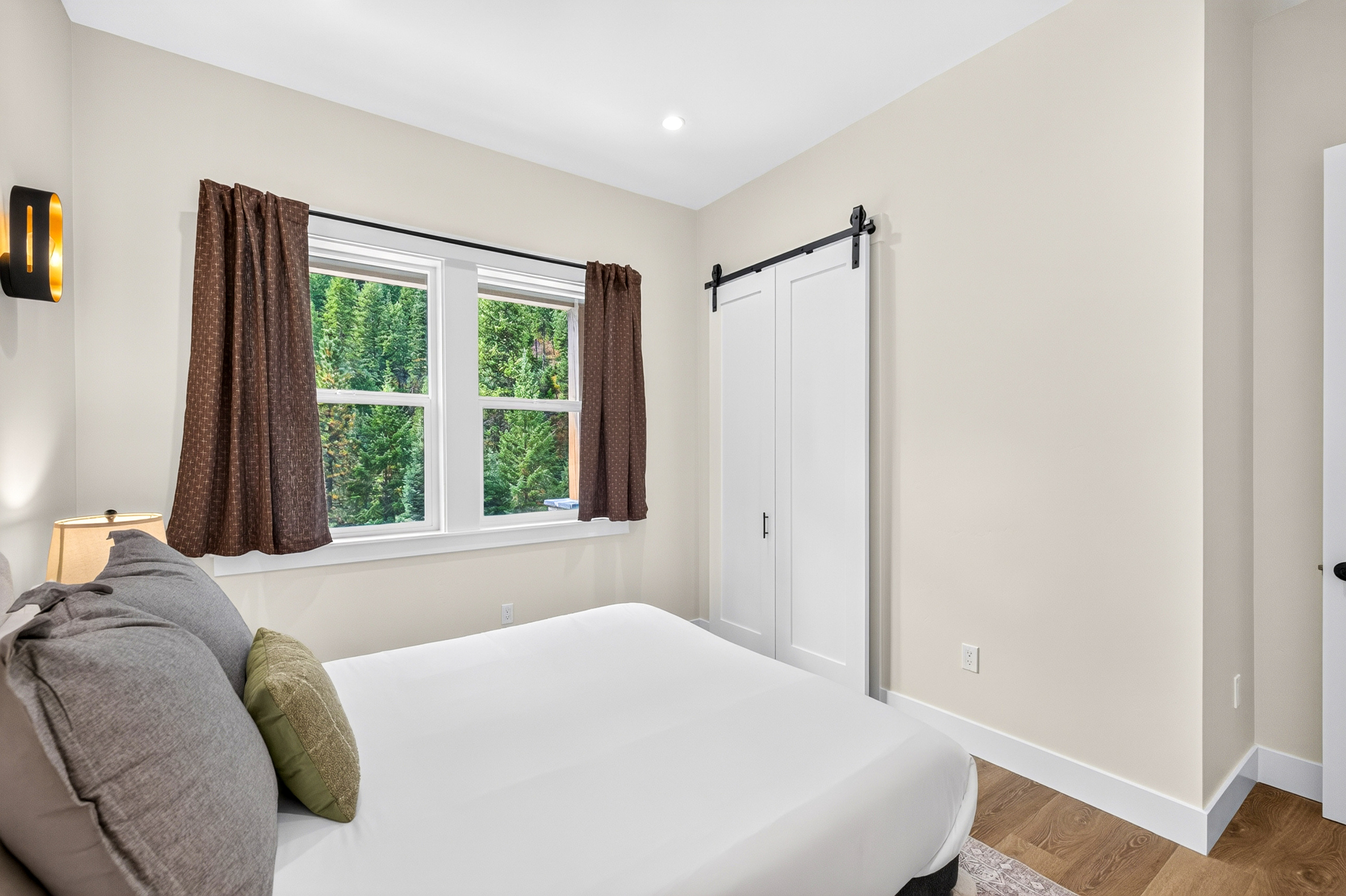 View out the side window of bedroom 2 with a queen bed.