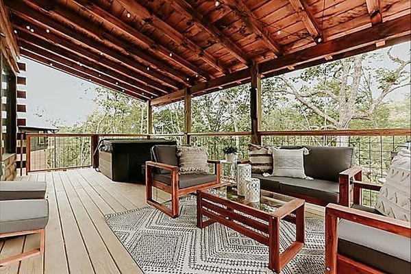 Enjoy meals al fresco on the covered deck, surrounded by fresh mountain air and treetop views