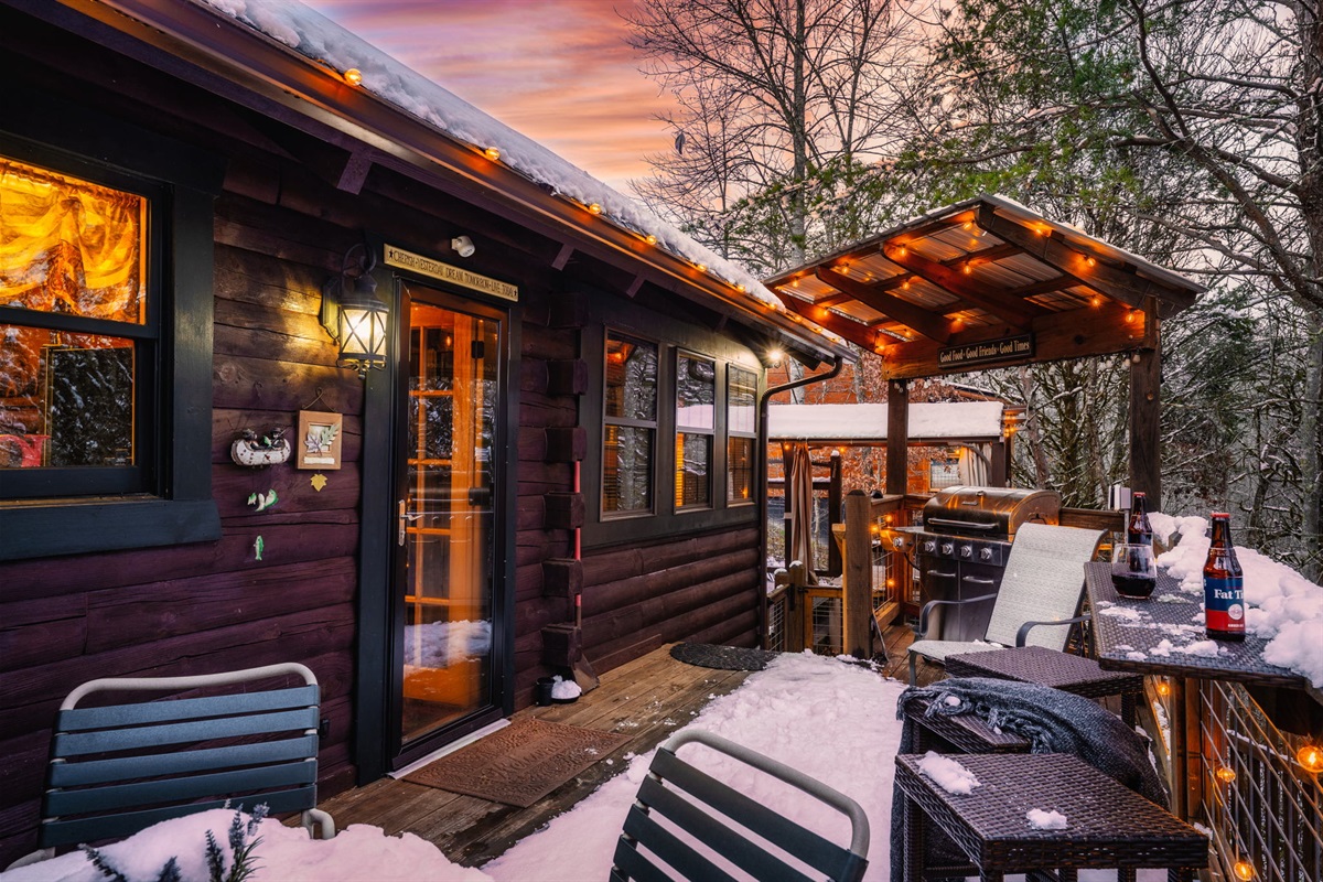 Backyard deck with a Weber charcoal grill and outdoor dining furniture