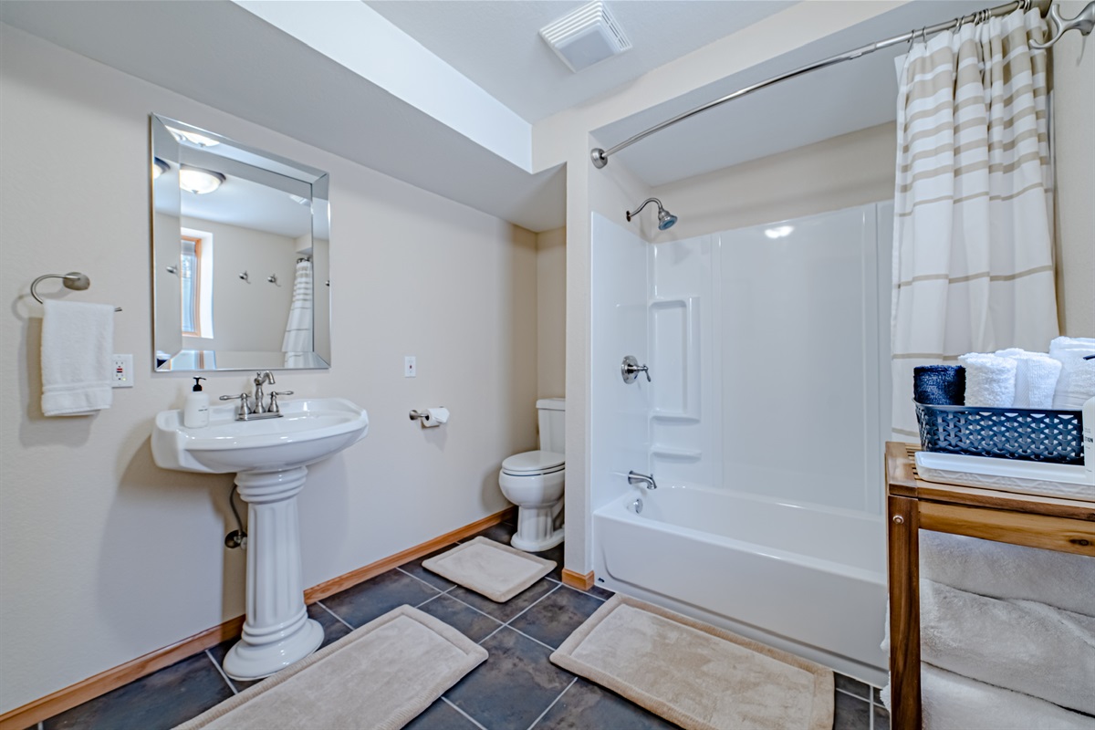 Full bathroom downstairs with a tub/shower combo.