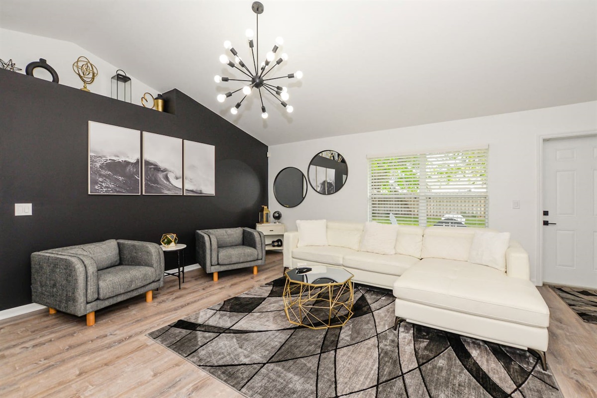Elegant living space with stylish couches, modern décor, and a cozy ambiance.