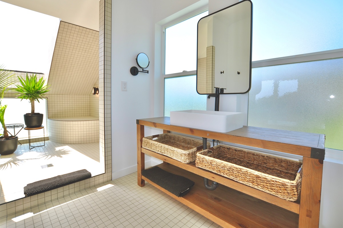 Spacious bathroom with plenty of natural light and a luxurious shower.