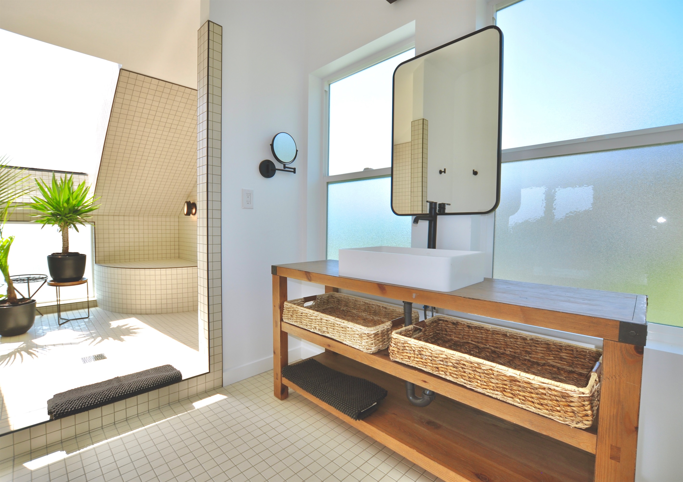 Spacious bathroom with plenty of natural light and a luxurious shower.