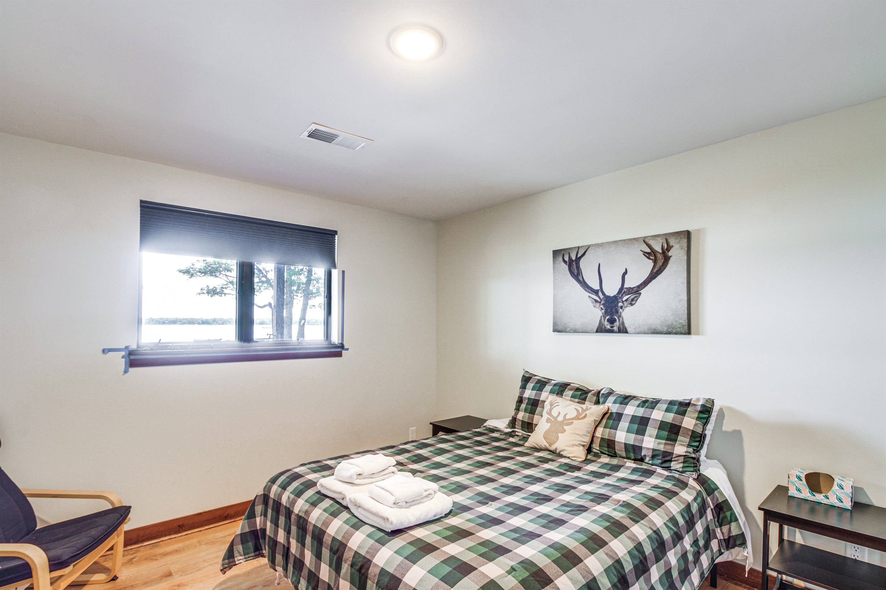 Lower-level bedroom with queen bed and peaceful lake views