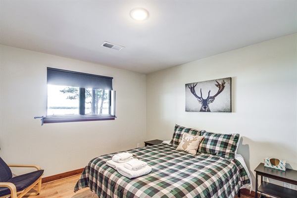 Lower-level bedroom with queen bed and peaceful lake views