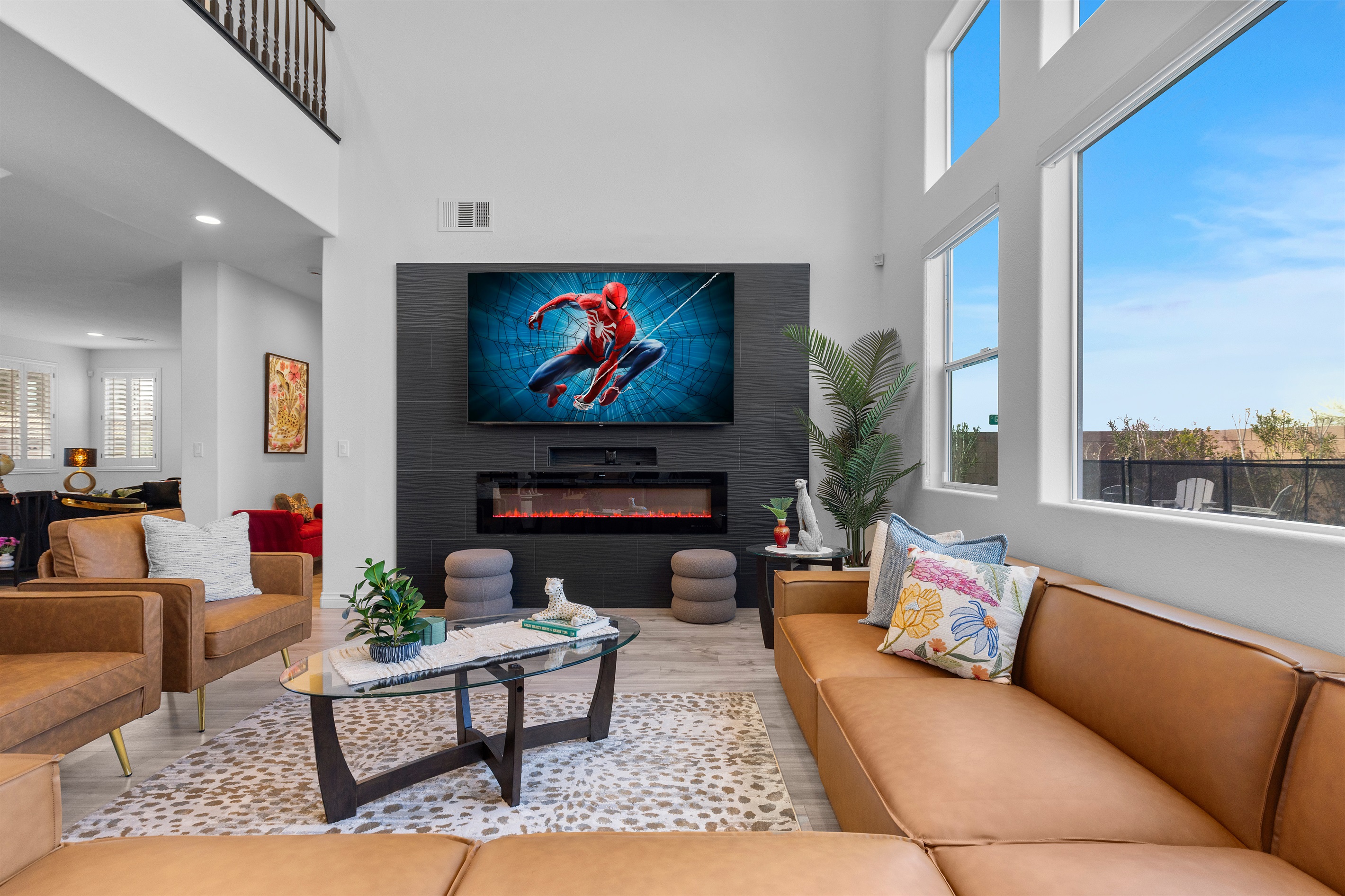 Main Living Room with vaulted ceiling, electric fireplace, and a 85" 4K TV.  A fantastic gathering place for your group. -It's Showtime!