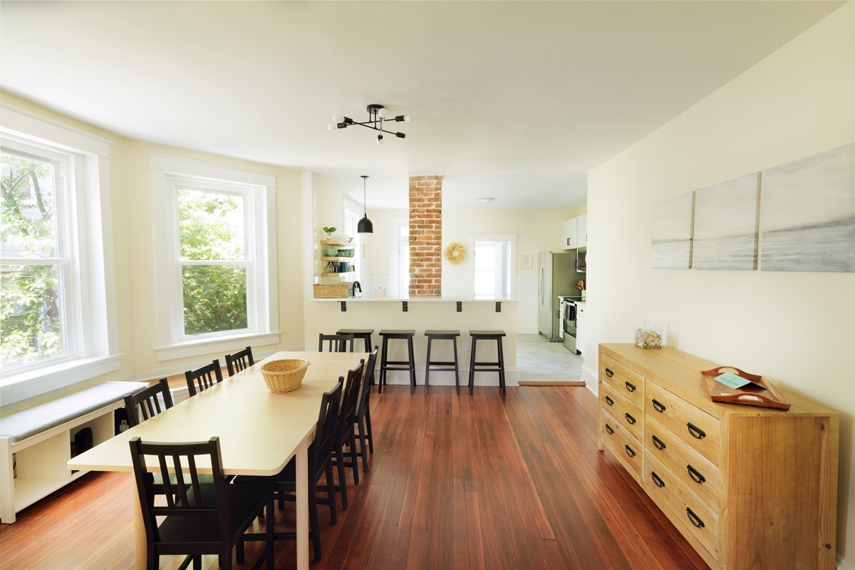 Large dining area with seating for eight at the kitchen table and four at the bar.