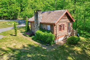 From the yard facing the log cabin and the street