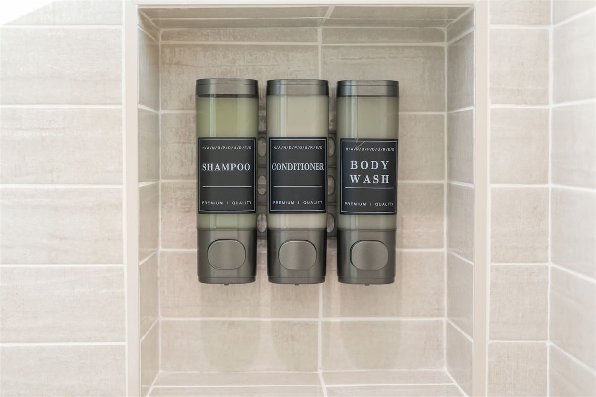 Convenient shower amenities with premium shampoo, conditioner, and body wash provided.
