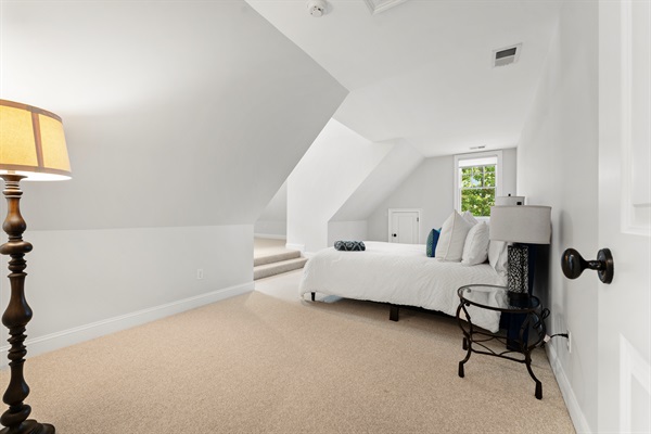 Upstairs Bedroom 4 offers a restful escape with a plush queen bed