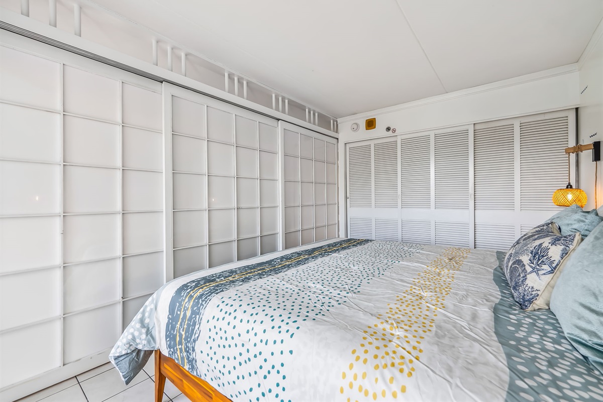 Bedroom angle view showing sliding doors utilized to separate it from the living area for privacy.  Closet located in bedroom